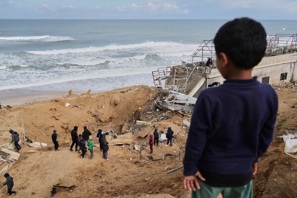 Palestinians inspect the rubble of a structure hit by an Israeli bombardment in Deir al-Balah, Gaza Strip on Saturday, March 22, 2025. (AP Photo/Abdel Kareem Hana)