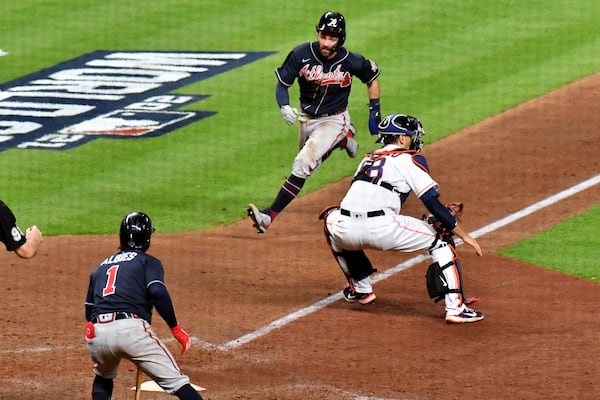 Braves shortstop Dansby Swanson scores a run ahead of the tag by Houston Astros catcher Jason Castro (18) during the eighth inning in game 1 of the World Series at Minute Maid Park, Tuesday October 26, 2021, in Houston, Tx. Hyosub Shin / Hyosub.Shin@ajc.com