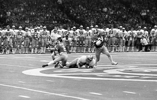 QB Buck Belue tries to make a block as Herschel Walker reverses direction against Notre Dame in the Sugar Bowl. AJC file photo