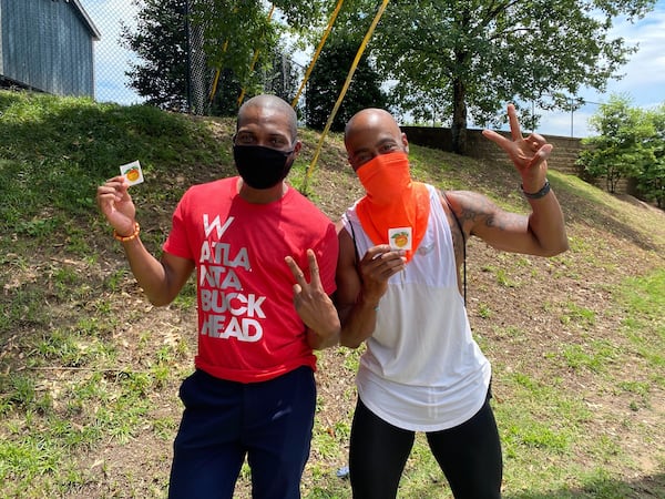 Joshwa Preston (left) and Denerick Lindsey pose with their “I am a Georgia voter!” stickers after waiting three hours to cast their ballots at Garden Hills Elementary School on Friday, June 5, 2020. It was the last day of early voting for this election season. (Ben Brasch/AJC)