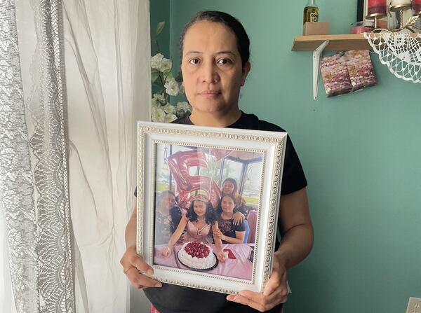 Maria Bran holds a photo of her daughter Susana Morales.