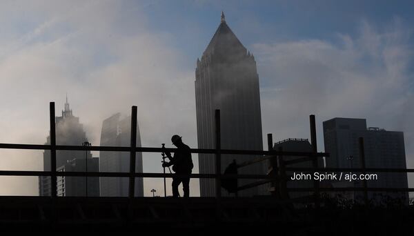 Fog hovers over the downtown skyline as work continues at Atlantic Yards on 17th Street.