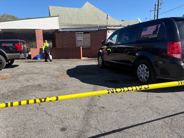 Caution tape surrounds a Cobb County funeral home after cremated remains were found inside this week, leading to a police investigation, authorities said.