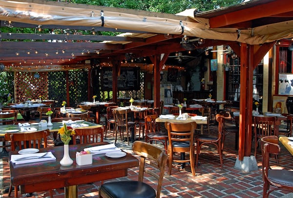 A garden-enveloped patio creates a charming vibe for dining al fresco at Anis Bistro in Buckhead. CONTRIBUTED BY PHILIP SHONE