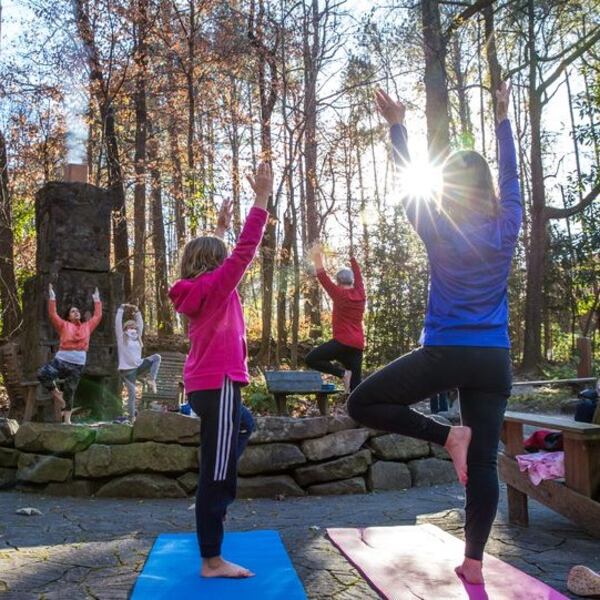 Unwind with full body flow yoga by the Dunwoody Nature Center’s outdoor fireplace.