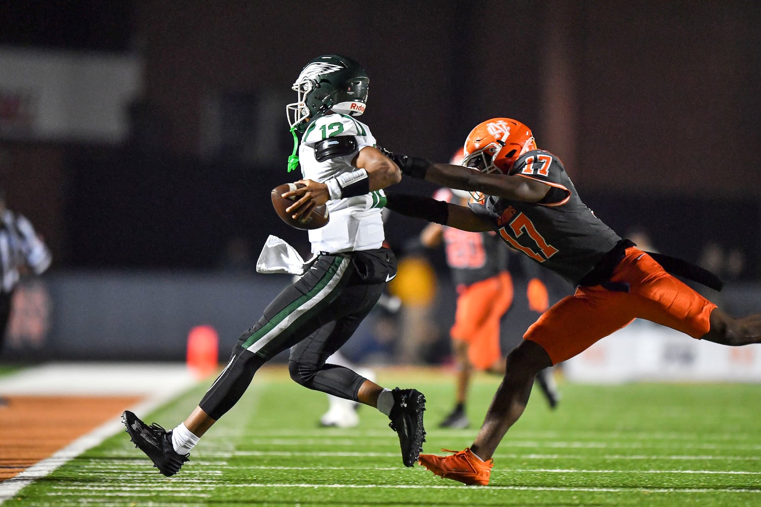 North Cobb James Askew (17) chases Collins Hill quarterback RJ Wilcox (12) out of bounds during the first half of play Friday, Nov. 10, 2023 at North Cobb High School. (Daniel Varnado/For the AJC)