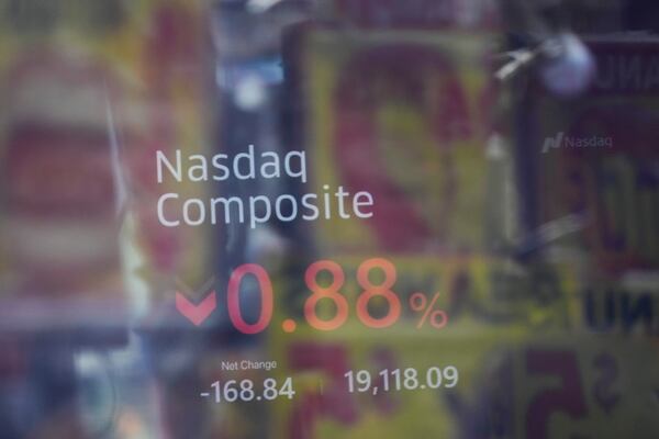 Signage in Times Square is reflected in the windows of the Nasdaq MarketSite in New York, Tuesday, Feb. 25, 2025. (AP Photo/Seth Wenig)