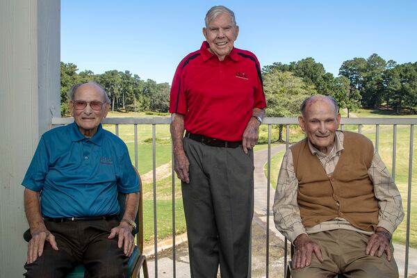 Twin brothers James, left, and Jennings Watkins, right, sit for a portrait with their friend Bo Cline, center, during the Golf Classic for CURE Childhood Cancer Tournament at the Oaks Golf Course in Covington. (Alyssa Pointer/Atlanta Journal Constitution)