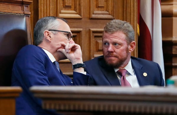 Lt. Gov. Casey Cagle and Gov. Deal's chief of staff Chris Riley confer in the senate before the Senate earlier this month. BOB ANDRES /BANDRES@AJC.COM