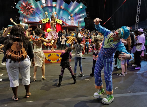 Ringling Bros. and Barnum & Bailey clowns dance with fans during a pre show for fans Saturday, Jan. 14, 2017, in Orlando, Fla. The Ringling Bros. and Barnum & Bailey Circus will end the "The Greatest Show on Earth" in May, following a 146-year run of performances. Kenneth Feld, the chairman and CEO of Feld Entertainment, which owns the circus, told The Associated Press, declining attendance combined with high operating costs are among the reasons for closing. (AP Photo/Chris O'Meara)