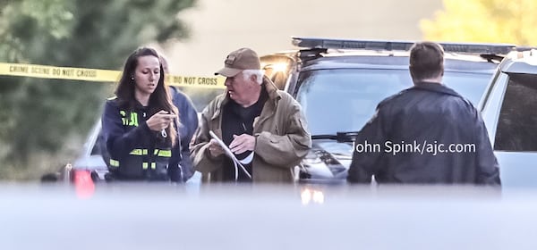 GBI agents speak with Carroll County sheriff's deputies on the scene of an officer-involved shooting Monday morning on Ga. 61.