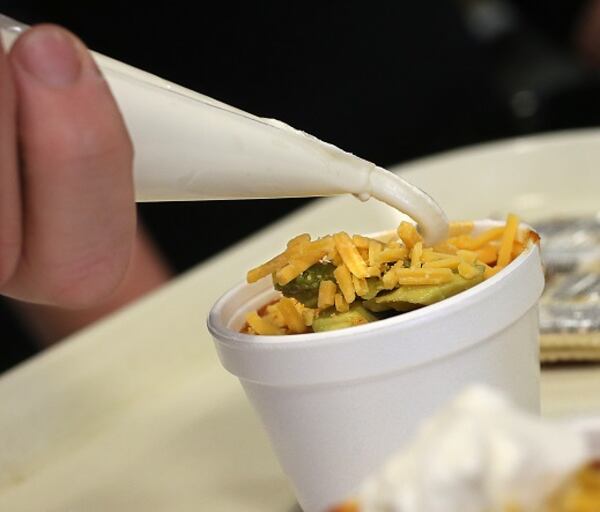 The City of Akron Human Resources Department's "Wholly Chili" is served at the 11th Annual Akron Firefighters Chili Challenge at Lock 3 Park on January 20, 2017, in Akron, Ohio. From left are Lt. Sierjie Lash, Capt. Scott Pascu, and Firefighter Adam Lovell. (Phil Masturzo/Akron Beacon Journal/TNS)