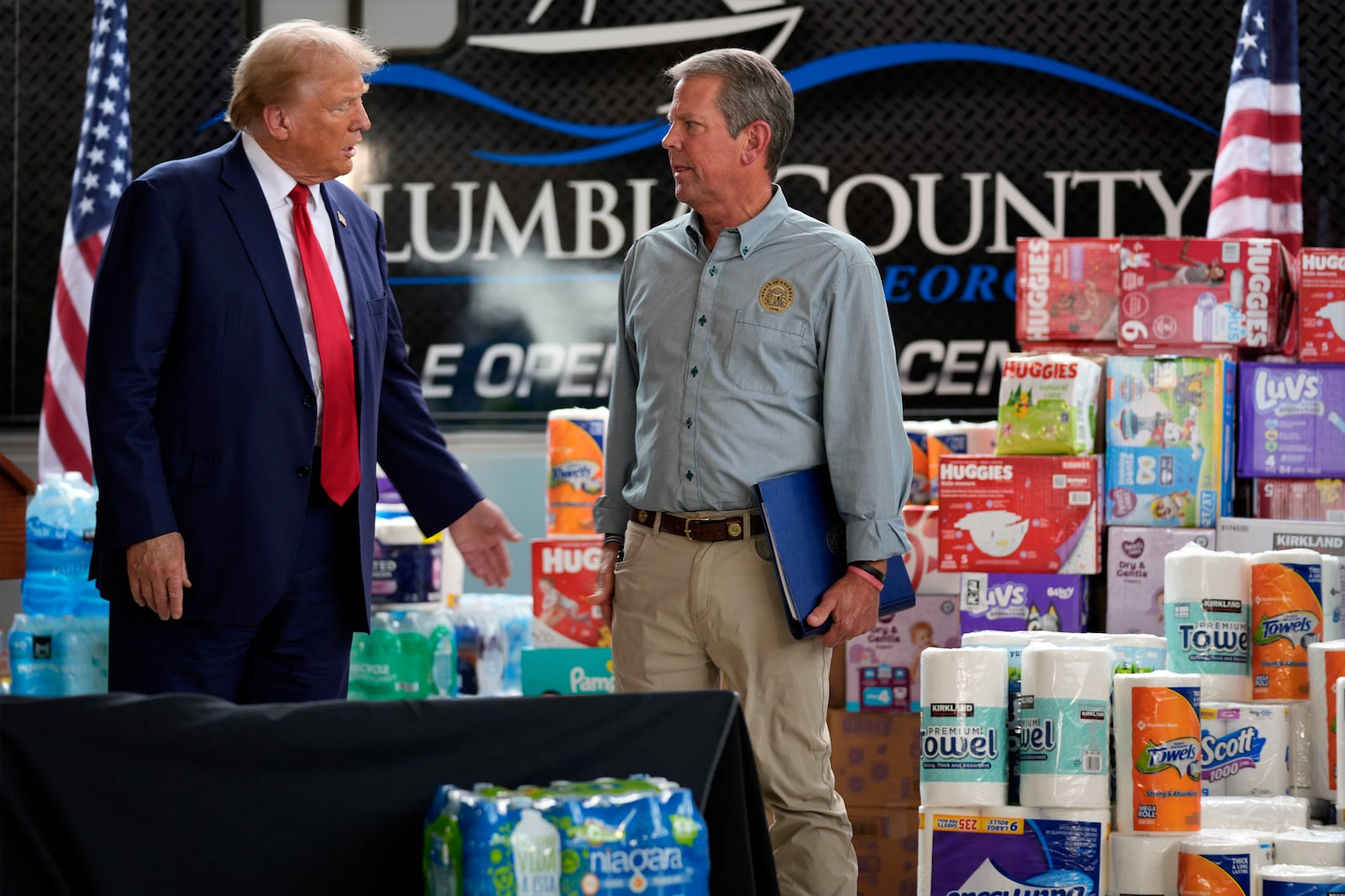 Former President Donald Trump, the Republican presidential nominee, talks with Gov. Brian Kemp after speaking at a temporary relief shelter during a tour of damage from Hurricane Helene in Evans. Trump also used the visit as an opportunity to patch up his relationship with Kemp, which has been strained for years and occasionally erupted in outbursts by the former president. Evan Vucci/AP file