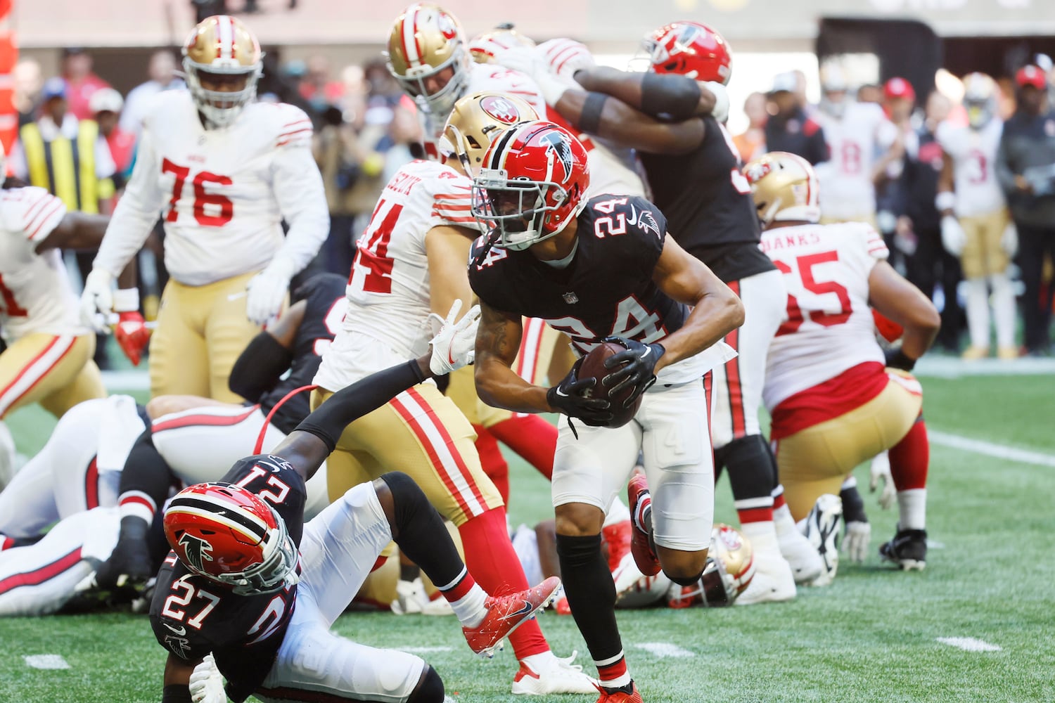 Falcons cornerback A.J. Terrell recovers a fumble against the 49ers on Sunday in Atlanta. (Miguel Martinez / miguel.martinezjimenez@ajc.com)