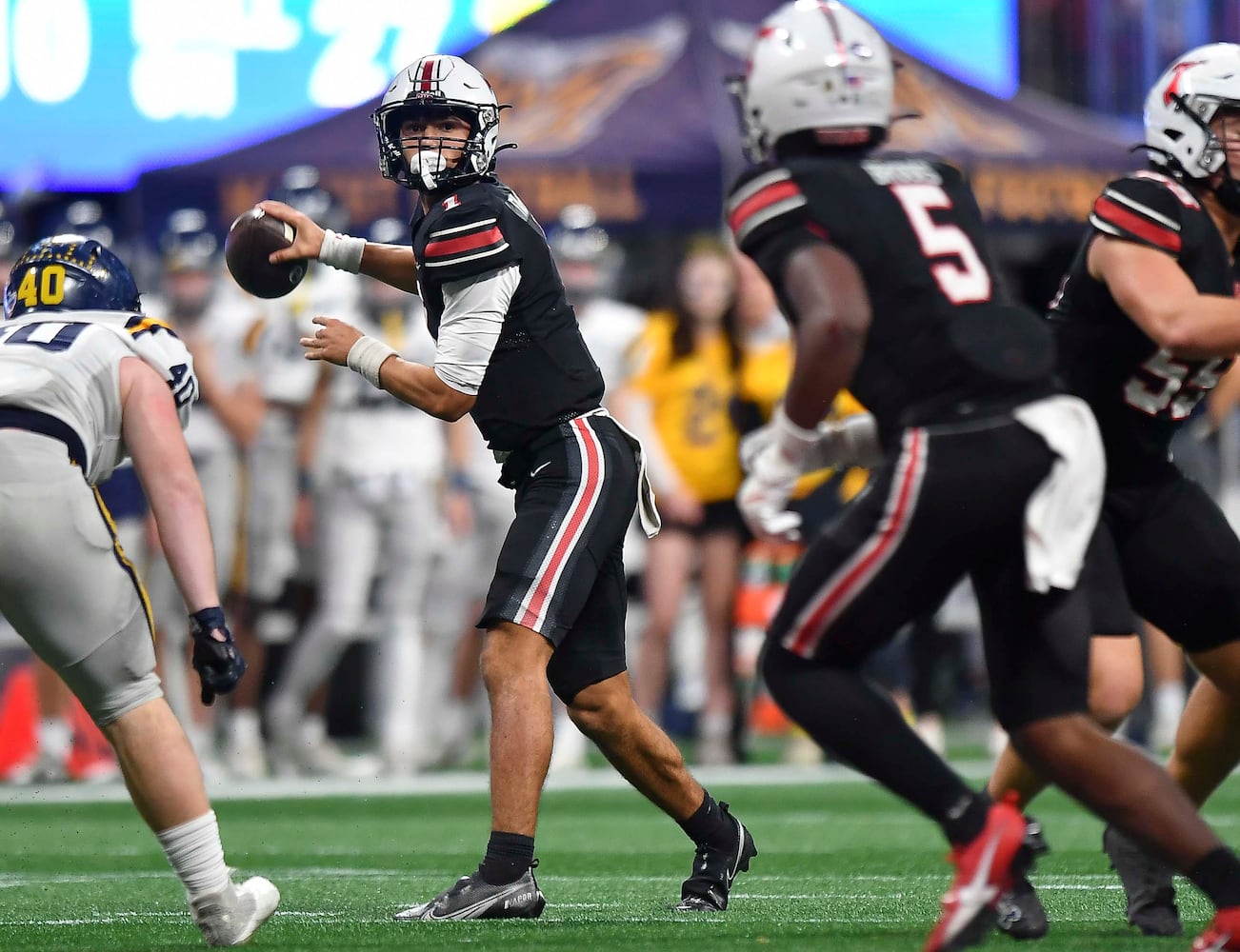 North Oconee’s quarterback Harrison Faulkner (1) looks for an open receiver during the second half of a Class 4A championship game at the Mercedes-Benz Stadium Monday, Dec. 16, 2024. (Photo/Daniel Varnado)