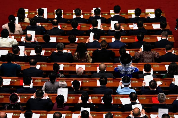 Delegates attend the closing ceremony of the National People's Congress held at the Great Hall of the People in Beijing, Tuesday, March 11, 2025. (AP Photo/Ng Han Guan)