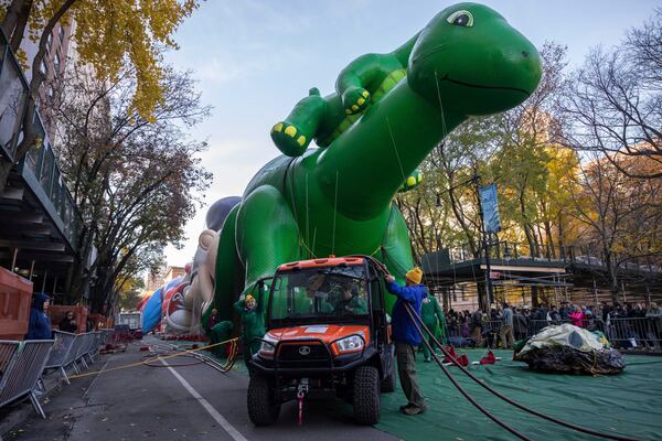 People inflate a float of Sinclair's Dino in preparation for the Macy's Thanksgiving Day Parade, Wednesday, Nov. 27, 2024, in New York. (AP Photo/Yuki Iwamura)