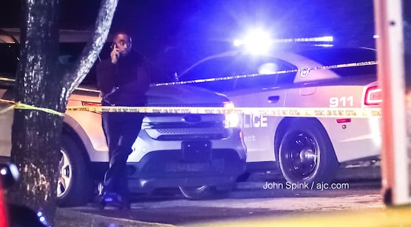 A Riverdale police officer was on the scene of a deadly shooting investigation at a townhome complex on Roy Huie Road. JOHN SPINK / JSPINK@AJC.COM