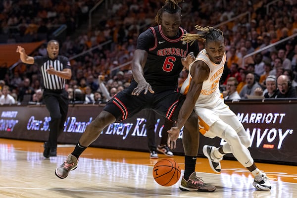 Tennessee guard Jahmai Mashack (15) battles for the ball with Georgia center Somto Cyril (6) during the first half of an NCAA college basketball game Wednesday, Jan. 15, 2025, in Knoxville, Tenn. (AP Photo/Wade Payne)