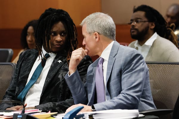 Atlanta rapper Young Thug (left) whose real name is Jeffery Williams, speaks with his attorney Brian Steel during a court hearing.