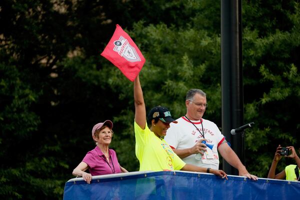 Atlanta Mayor Keisha Lance Bottoms starts the AJC Peachtree Road Race on Thursday, July 4, 2019. Blowing the air horn is Tim Singleton Jr., the son of race founder Tim Singleton. In the background is Julia Emmons, who was the Atlanta Track Club executive director from 1985 to 2006 and oversaw significant expansion of the race field.