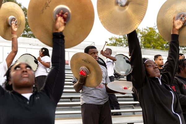 Clark Atlanta University senior drum major Nyzaiha Daniels (center), a former cymbal player in the band, practices at Panther Stadium at Clark Atlanta University in Atlanta on Thursday, October 10, 2024. He often has to show the drum line that he still has his chops. Daniels and his twin brother,  Izaiha Daniels, both serve as drum majors. (Arvin Temkar / AJC)