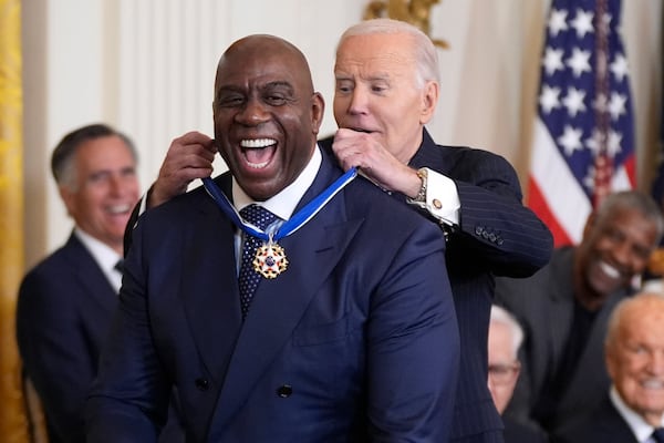 President Joe Biden, right, presents the Presidential Medal of Freedom, the Nation's highest civilian honor, to Earvin "Magic" Johnson in the East Room of the White House, Saturday, Jan. 4, 2025, in Washington. (AP Photo/Manuel Balce Ceneta)