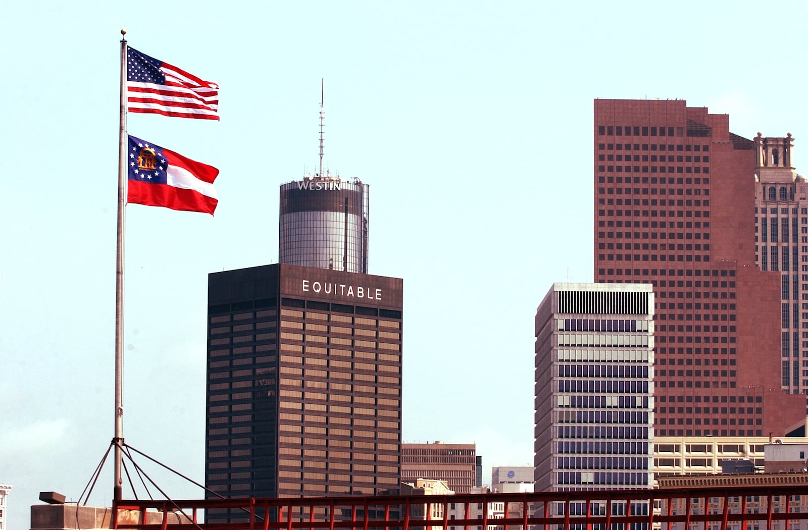 Georgia's new state flag flies above the Capitol and downtown Atlanta skyline after Gov. Sonny Perdue signed it into law in 2003. The current state flag was at the time the third flag to rise over the state house since 2001, when the Georgia flag bearing the Confederate battle emblem was changed and a legislative showdown ensued. -- Gallery by Mandi Albright, AJC