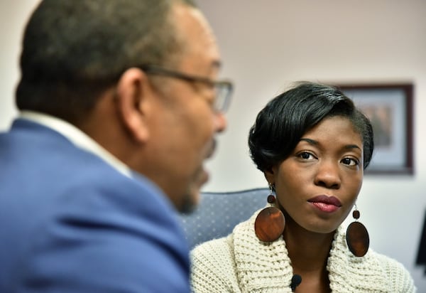 Janelle Jones looks as Leo Smith, the Minority Engagement Director for the Georgia Republican Party, talks at Georgia Republican Party Headquarters on Tuesday, December 20, 2016. HYOSUB SHIN / HSHIN@AJC.COM