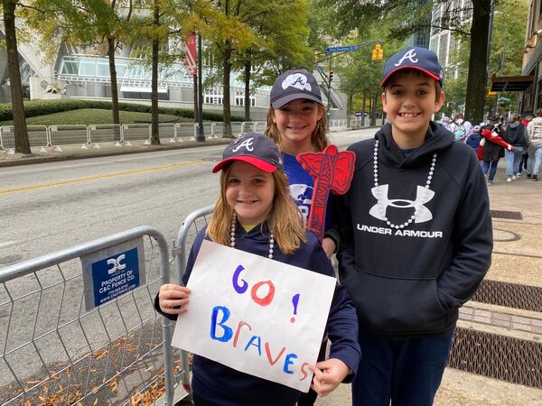 Siblings Harper, 8, Hattie, 10, and Hank, 12, Vaughn of Griffin, Georgia got to the parade route early Friday with their parents. The homeschooled family said it was an easy decision to take a day off from schoolwork to attend the celebration. VANESSA McCRAY/ AJC