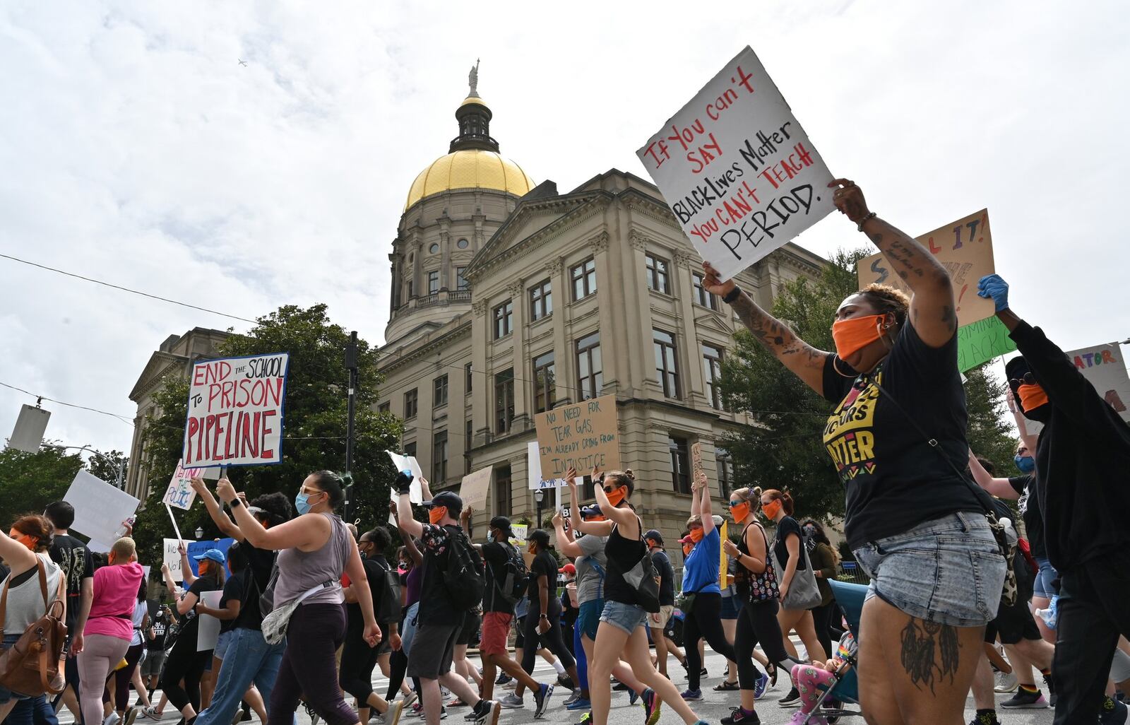 Educators march past the Georgia State Capitol while the last day of the legislative session is in session at Georgia State Capitol on Friday, June 26, 2020. The Atlanta NAACP joined with the Educators for Black Lives March to demand changes in school policing. The Atlanta NAACP held another rally the next day, Saturday, June 27, 2020 demanding justice for men and women killed by law enforcement. HYOSUB SHIN / HYOSUB SHIN@AJC.COM