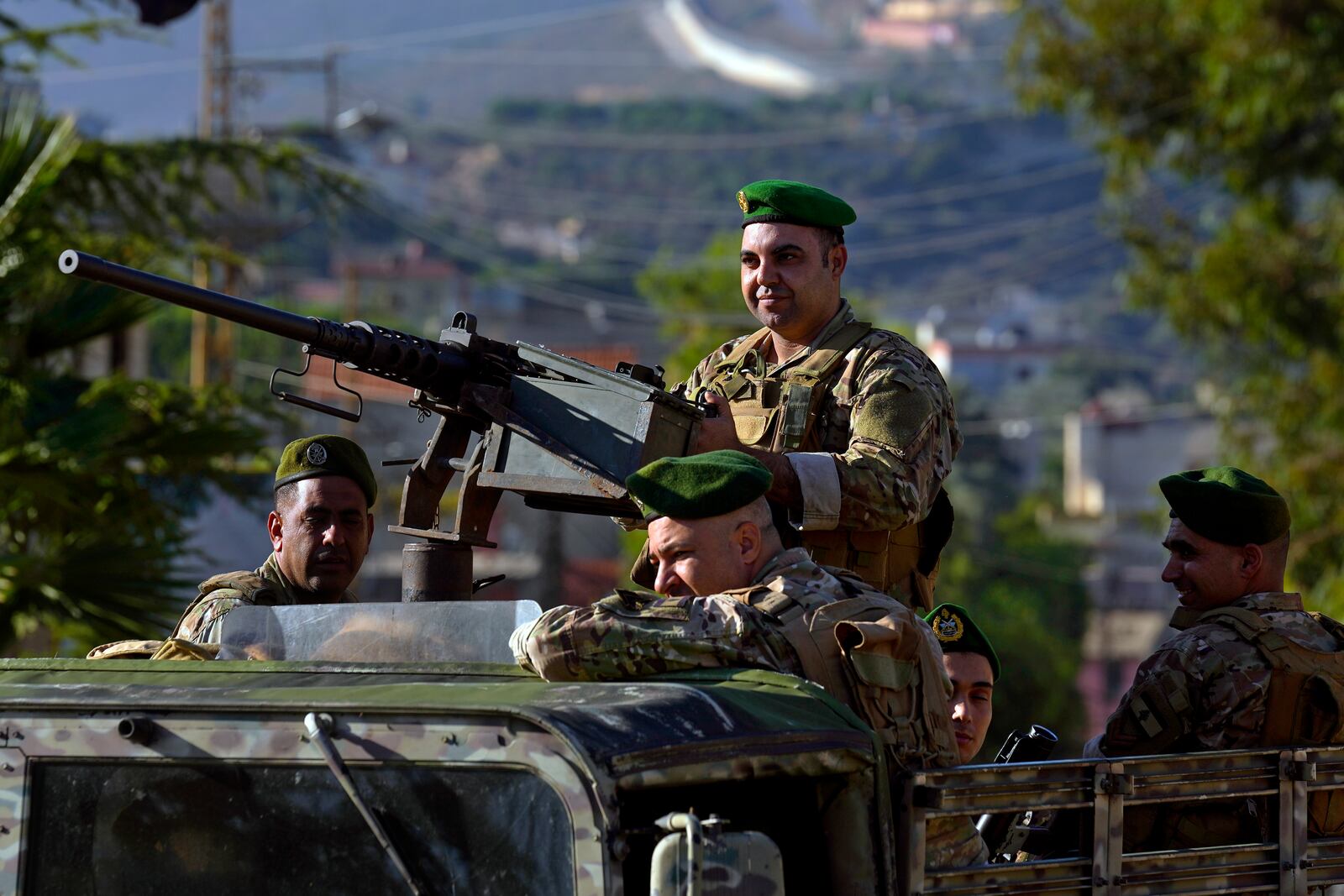 FILE - Lebanese army soldiers sit on their armored vehicle as they patrol the Lebanese side of the Lebanese-Israeli border in the southern village of Kfar Kila, Lebanon, on Oct. 13, 2023. (AP Photo/Bilal Hussein, File)