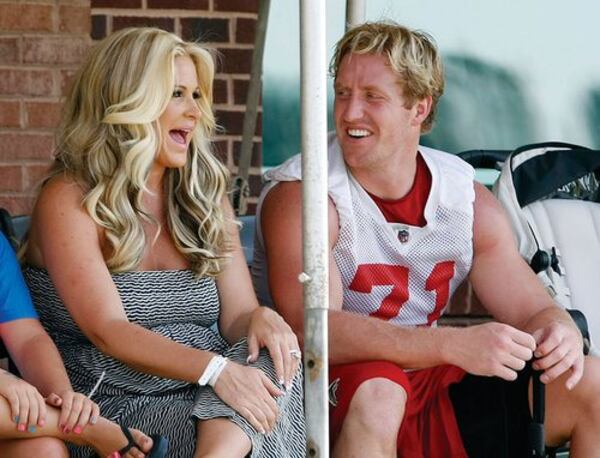 Falcons defensive end Kroy Biermann shares a laugh with his wife, Kim Zolciak, at the end of team practice on the first day of minicamp in Flowery Branch on Tuesday, June 19, 2012. CURTIS COMPTON / AJC file