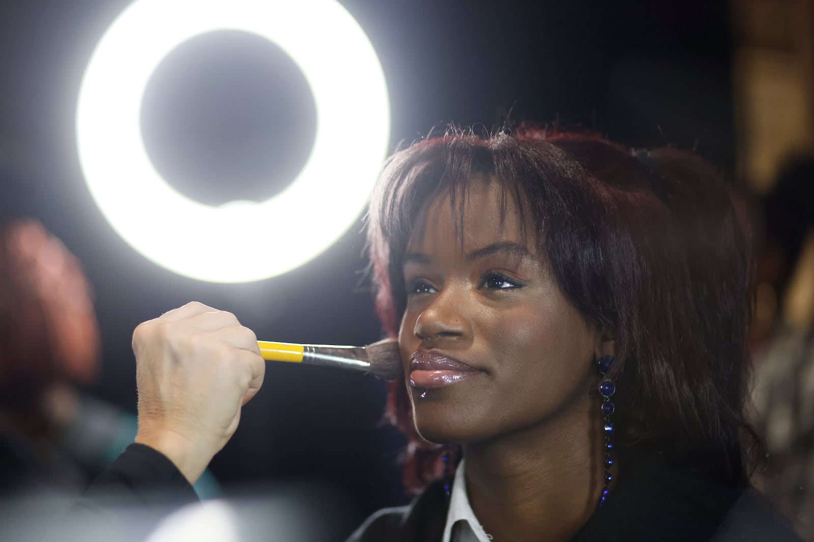 After she says "yes" to her new prom dress, McNair High School senior Najah Womack gets her makeup done during the “Say Yes to the Prom” event at Warner Brothers Discovery's campus in Midtown on Tuesday, Feb. 6, 2024. (Miguel Martinez /miguel.martinezjimenez@ajc.com)