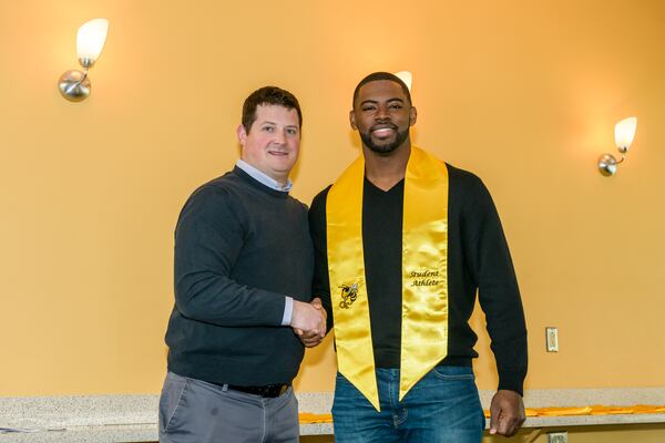 Georgia Tech assistant athletic director Chris Breen with former Tech captain KeShun Freeman as he was graduating in December 2017. (Danny Karnik/Georgia Tech Athletics)