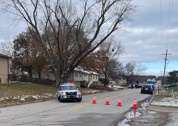 Police vehicles with flashing lights surround the Edwardsville, Kan., home of former police detective Roger Golubski on Monday, Dec. 2, 2024. (AP Photo/Heather Hollingsworth)