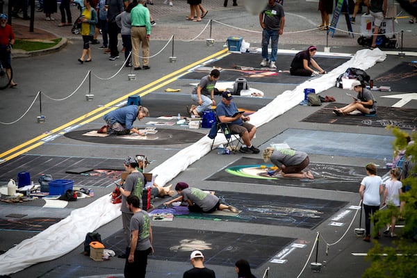 Artists work on their chalk drawings during the Chalk Art Competition at the 2017 Chalktoberfest on the Marietta Square in Marietta GA Saturday, October 14, 2017. STEVE SCHAEFER / SPECIAL TO THE AJC