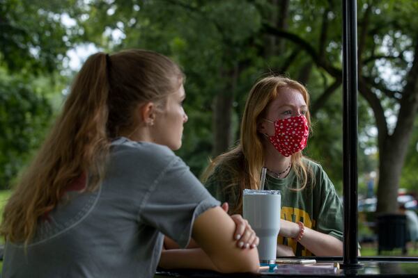 Georgia College and State University freshman Emily Brown (right) wears a face mask as she talks about her experience being back on campus with the risk of COVID-19 in Milledgeville, Friday, Aug. 21, 2020.  (ALYSSA POINTER / ALYSSA.POINTER@AJC.COM)