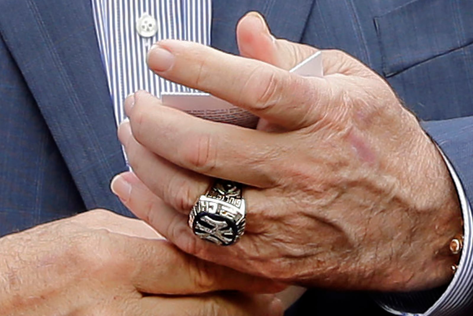 FILE - Rudy Giuliani, wearing one of his Yankees' championship rings, talks with people on the field before the game between the New York Yankees and the Houston Astros at Yankee Stadium, May 28, 2018, in New York. (AP Photo/Seth Wenig, File)