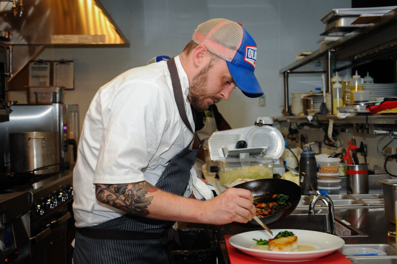 Chef de cuisine Jeb Aldrich in the kitchen at Noble Fin in Peachtree Corners. (BECKY STEIN PHOTOGRAPHY)