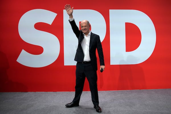 German Chancellor Olaf Scholz waves after first projections are announced during the election party at the Social Democratic Party (SPD) headquarters in Berlin, Germany, Sunday, March 23, 2025. (AP Photo/Ebrahim Noroozi)