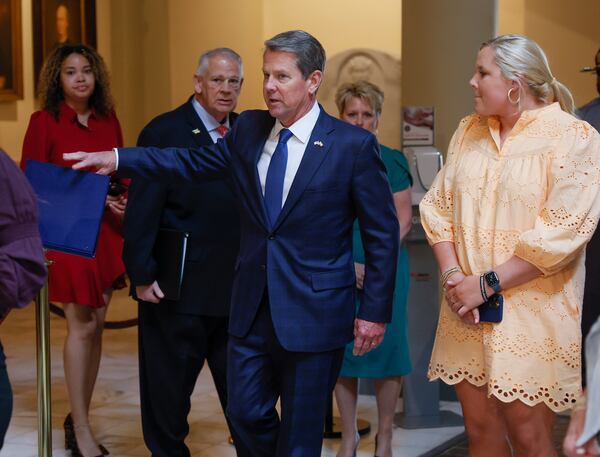 With his family and House Speaker David Ralston behind him, Gov. Brian Kemp heads from his office to sign House Bill 1013, which aims to increase access to mental health coverage in Georgia on Sine Die, the last day of the General Assembly, at the Georgia State Capitol in Atlanta on Monday, April 4, 2022.   (Bob Andres / robert.andres@ajc.com)