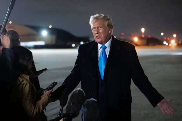 President Donald Trump speaks to reporters next to Air Force One after arriving back at Joint Base Andrews, Md., Sunday, Feb. 2, 2025. (AP Photo/Ben Curtis)