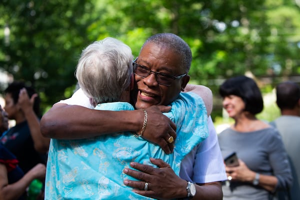 Avondale Estates postal clerk Russel Lewis (right) greets an Avondale Estates community member (left) during a retirement party for Lewis on Wednesday, June 30, 2021, at Willis Park in Avondale Estates, Georgia. The Avondale community threw the gathering in honor of Lewis who served at the Avondale post office for 25 years.  CHRISTINA MATACOTTA FOR THE ATLANTA JOURNAL-CONSTITUTION.