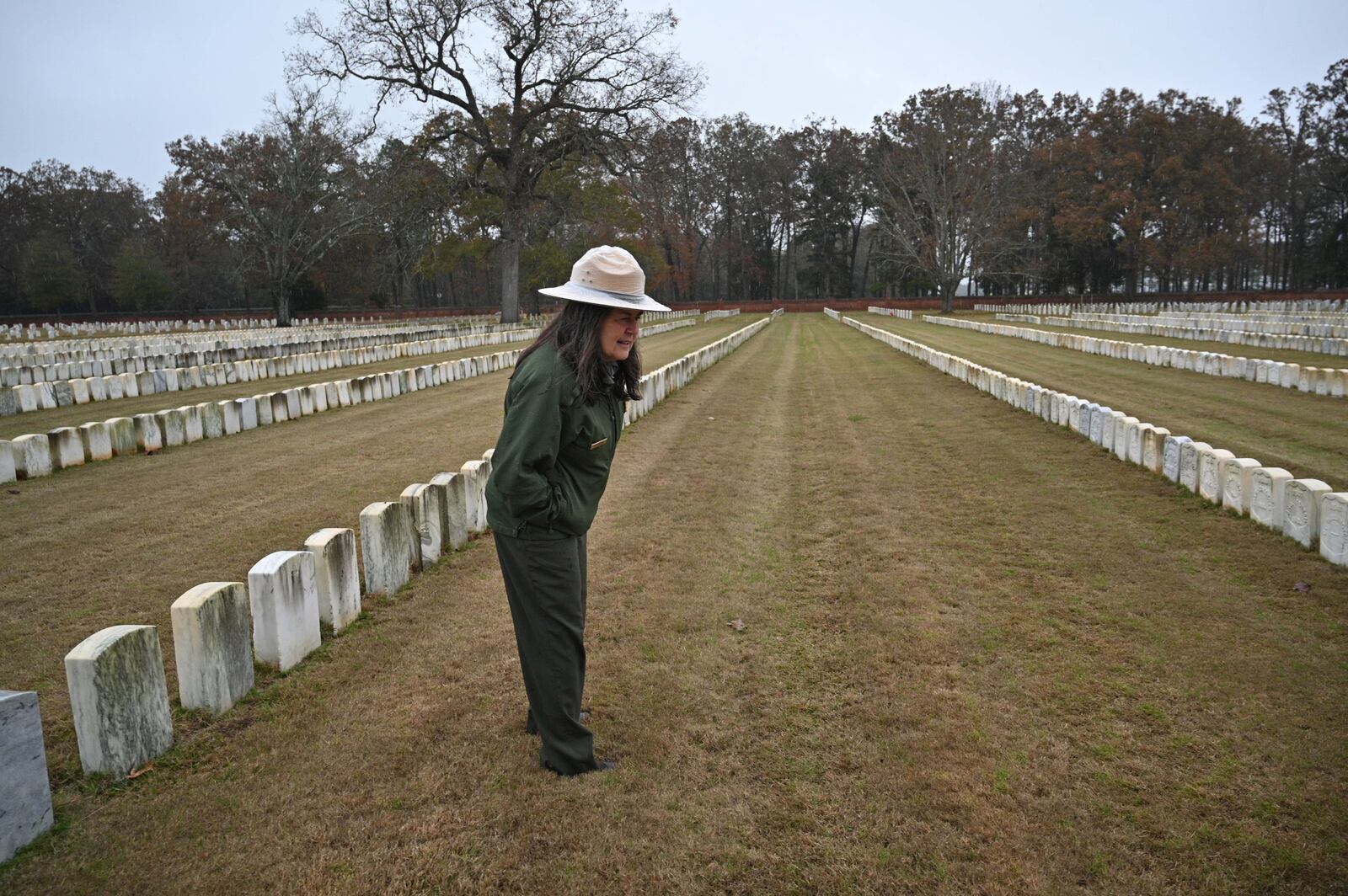 Gia Wagner, superintendent of the Andersonville National Historic Site, visited some of the graves of Irish Americans at the cemetery in November. "The discovery and sharing of these Irish American stories will allow all Americans, and especially Irish Americans, to learn about themselves, the drivers of Irish immigration prior to 1864, and the experiences of prisoners of war," she said.  (Hyosub Shin / Hyosub.Shin@ajc.com)