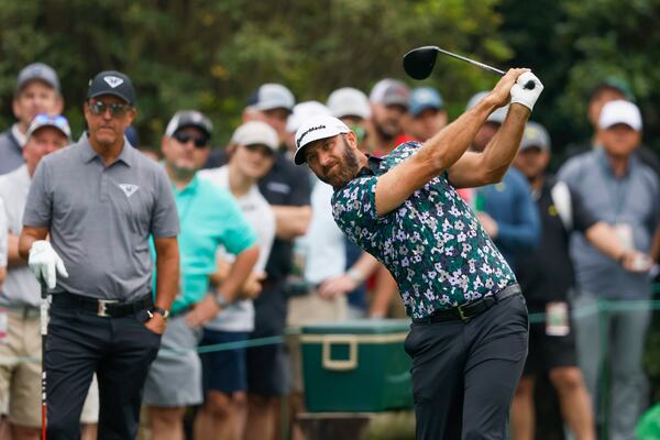 Dustin Johnson tees off on the 15th hole as Phil Mickelson watches during the practice round for the 2023 Masters Tournament at Augusta National Golf Club, Tuesday, April 4, 2023, in Augusta, Ga. Jason Getz / Jason.Getz@ajc.com)
