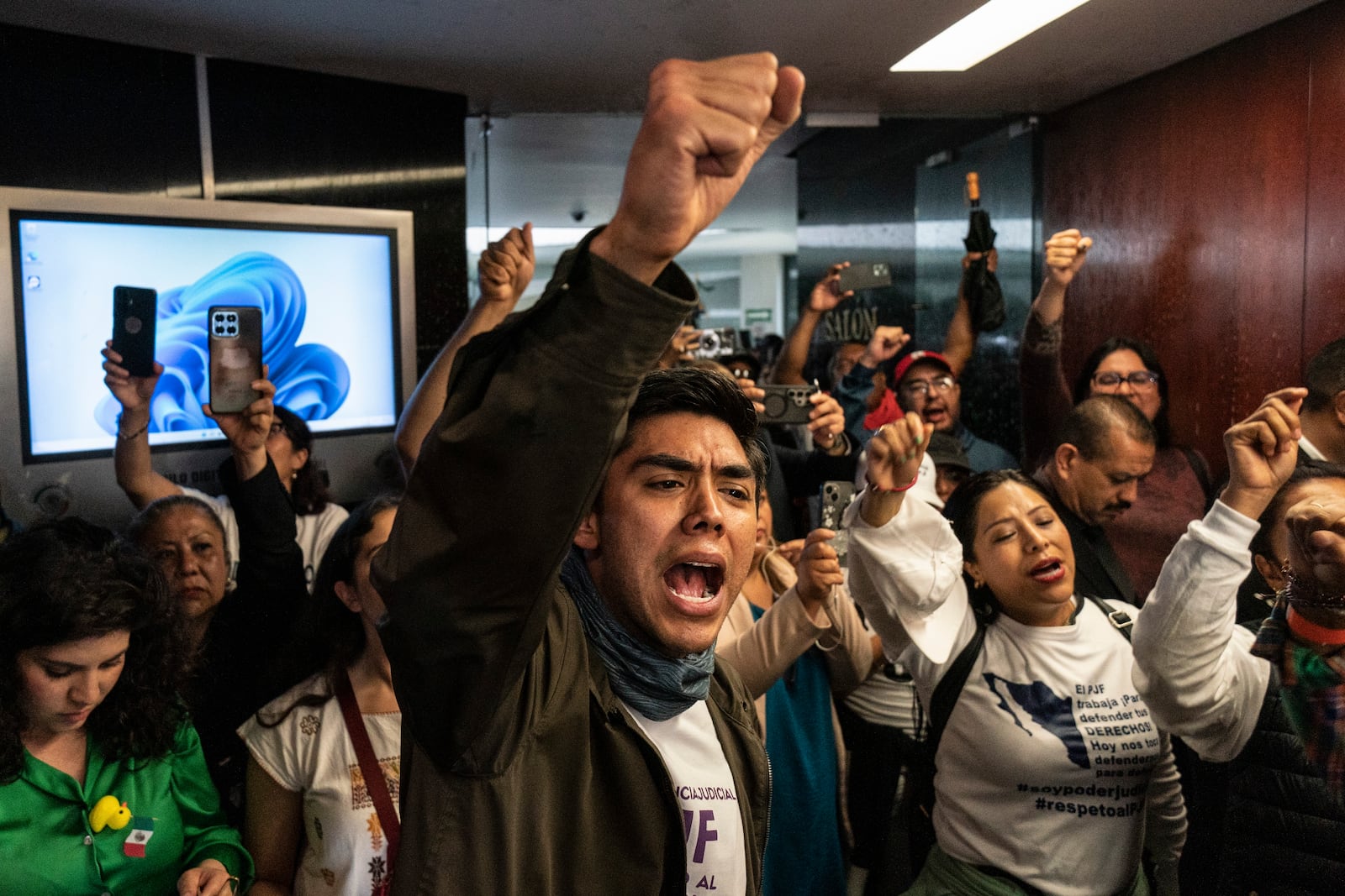 Protesters attempt to break into a room in the Senate as lawmakers weigh the government's proposed judicial reform, which would make judges stand for election, in Mexico City, Tuesday, Sept. 10, 2024. (AP Photo/Felix Marquez)