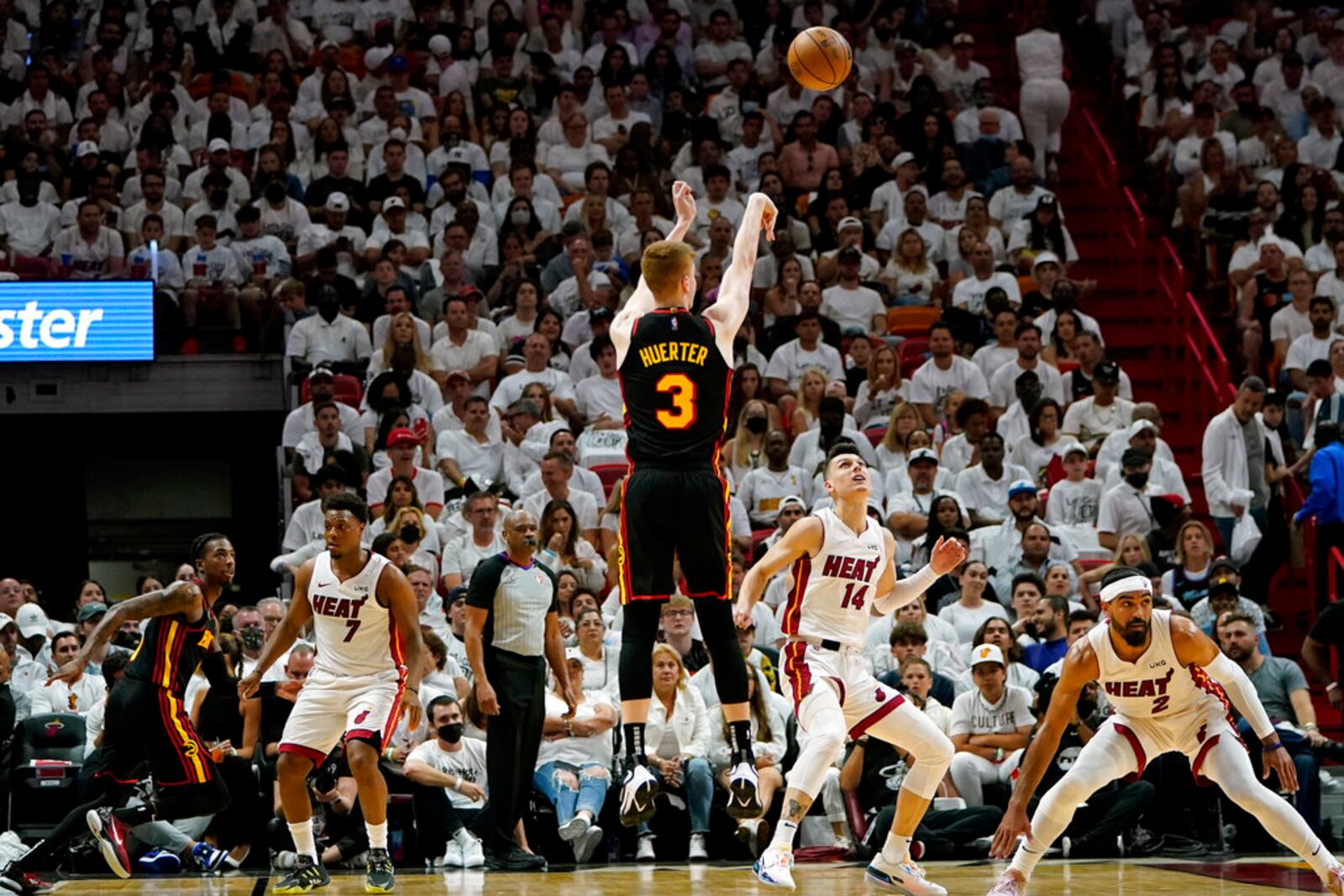 Atlanta Hawks guard Kevin Huerter (3) shoots over Miami Heat guard Tyler Herro (14) and guard Gabe Vincent (2) during the first half of Game 2 of an NBA basketball first-round playoff series, Tuesday, April 19, 2022, in Miami. (AP Photo/Lynne Sladky)