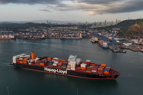 A cargo ship sails past the Panama Canal's Port of Balboa, managed by CK Hutchison Holdings, in Panama City, Thursday, March 13, 2025. (AP Photo/Matias Delacroix)