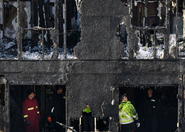 Police and firefighters investigate a house fire in the Spryfield community in Halifax, Nova Scotia, that killed all seven children in a Syrian refugee family Tuesday, Feb. 19, 2019. The children’s parents, Ebraheim and Kawthar Barho, who sought refuge for their family in September 2017, survived the fire, but Ebraheim Barho suffered life-threatening injuries when he went back into the burning home in an attempt to save the children, ages 14 to 4 months.